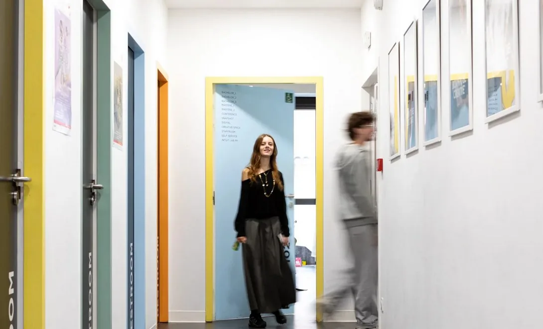 A corridor of the Paris campus with framed student work